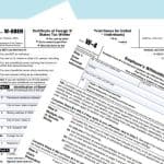 “W-9, W-8BEN, and W-4 IRS tax forms fanned out on a light blue background, visually comparing the documents used for U.S. contractors, foreign entities, and employees.”