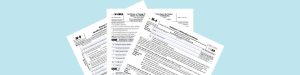 “W-9, W-8BEN, and W-4 IRS tax forms fanned out on a light blue background, visually comparing the documents used for U.S. contractors, foreign entities, and employees.”